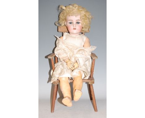 A Kammer &amp; Reinhardt for Simon &amp; Halbig bisque head doll, having fixed blue eyes, open mouth with two top teeth showi