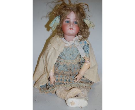 A Kammer & Reinhardt bisque head doll, having rolling blue eyes and open mouth with four top teeth showing, with jointed comp