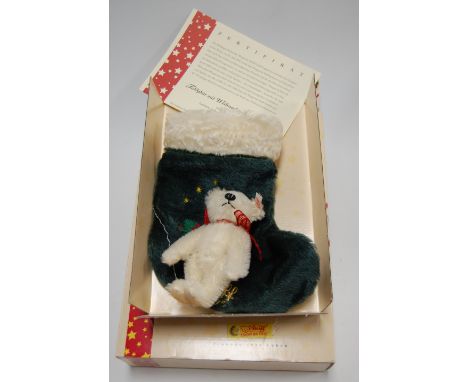 A Steiff teddy bear with Christmas Stocking 2005 , in white mohair, limited edition No. 310/5000, height 14cm, boxed, with ce