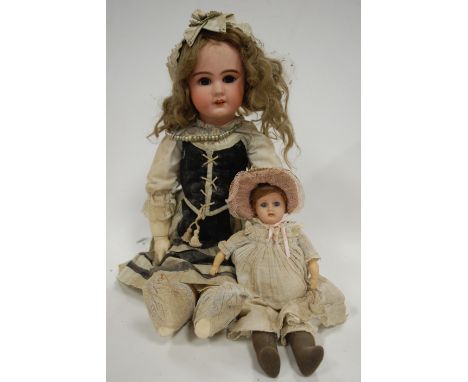 A German bisque head doll, having rolling brown eyes with painted brows and lashes, open mouth with four top teeth showing, w