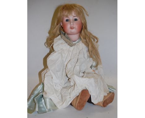 A William Goebel bisque head doll, having fixed blue eyes and open mouth with four top teeth showing, with jointed compositio