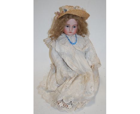 A Kammer & Reinhardt for Simon & Halbig bisque head doll, having fixed blue eyes with painted brows, open mouth with four top