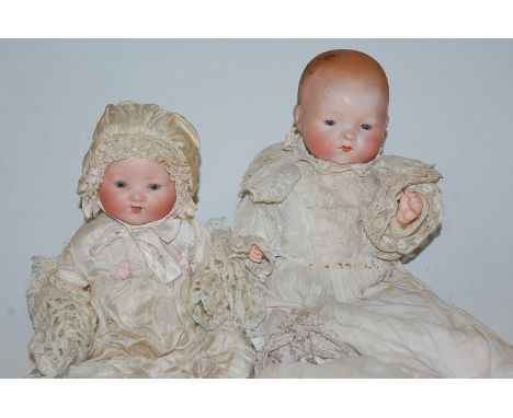 An Armand Marseille bisque head doll, having rolling blue eyes and open mouth with two bottom teeth showing, having bent limb