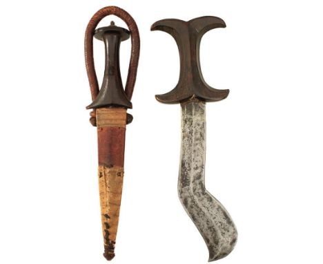 A 19TH CENTURY SUDANESE ARM DAGGER, of characteristic form, contained in its leather scabbard, together with a further Africa