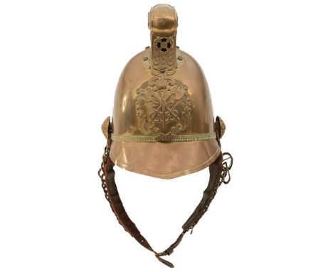 A 19TH CENTURY BRASS FIREMAN'S HELMET, the two-piece skull with embossed raised dragon comb, rose bosses, crossed axe and hos