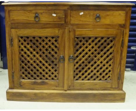 A modern Eastern hardwood sideboard of two drawers over two cupboard doors, on plinth base