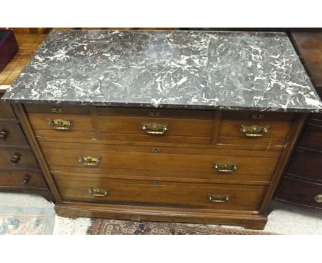 A late Victorian grey veined marble topped dressing chest of three short over two long drawers, on bracket feet