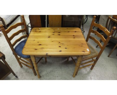 A rectangular pine table and set of four ladder back rush seated chairs