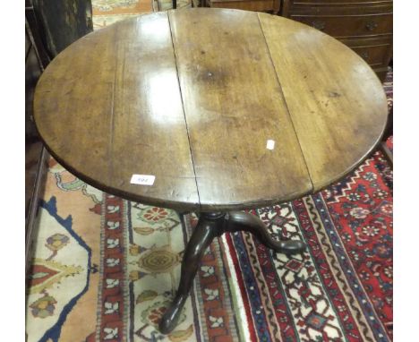 A 19th Century mahogany tea table, the circular snap top on a bird cage to baluster turned and ringed pedestal and cabriole t