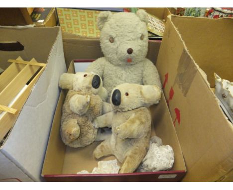 Two fur covered koala bear figures and a silver plush bear