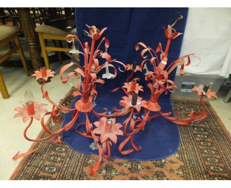 A pair of 20th Century red painted five light electroliers of foliate design