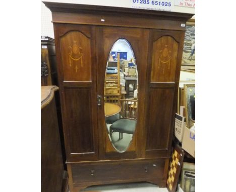 An Edwardian mahogany single wardrobe, with oval mirror to the door and single drawer under, to bracket feet