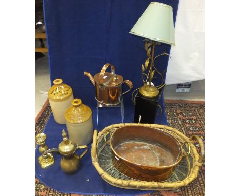 A collection of various copper and brass ware including watering can, candlestick, shot flask, a plated food cover, two-handl