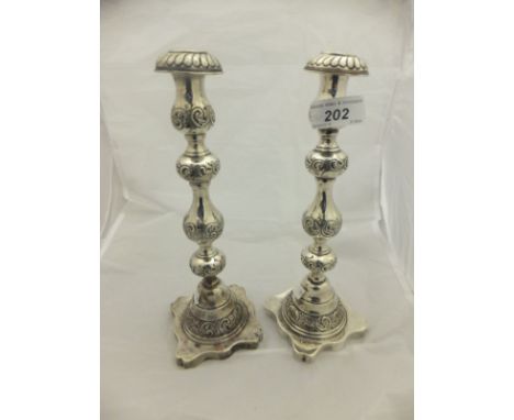 A pair of Victorian candlesticks of bobbin form with engraved C scroll decoration (London, 1862), together with assorted plat