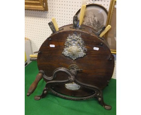 A Victorian oak cased knife cleaner bearing brass plaque inscribed "Kent Patentee and Manufacturer......" and an enamelled pl