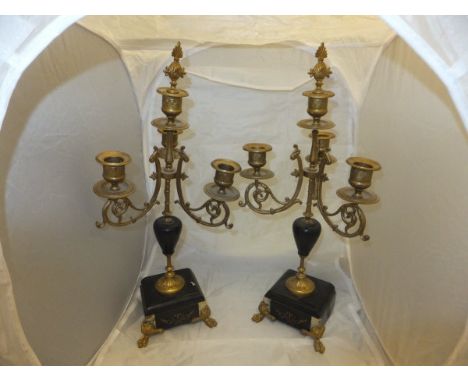 A pair of Empire style gilt metal and marble three branch four light candelabra