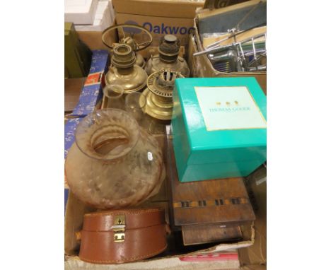 A box containing four assorted brass oil lamps and assorted glass funnels and shades, together with a box containing a Bolex 