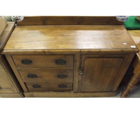 A Victorian pine dresser, the plain top above three drawers and single cupboard door, raised on a plinth base