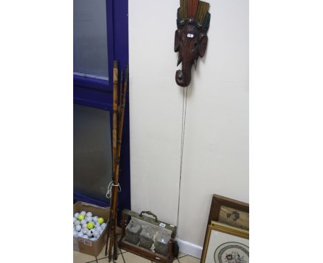 A TRIBAL ART HARD WOOD CLUB, a cuckoo clock, carved wooden mask, a cane four section fishing rod and an Edwardian three bottl