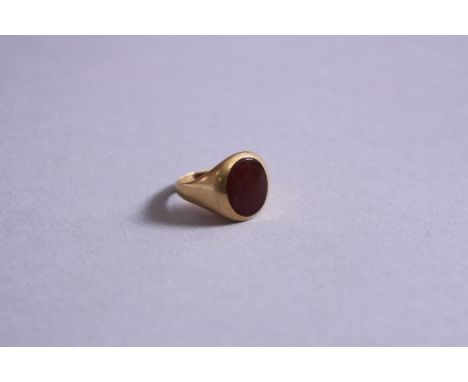 A CARNELIAN SIGNET RING, oval flat Carnelian measuring approximately 14 x 12mm, ring size approximately S, stamped 14k, inscr
