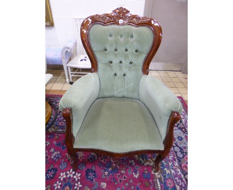 A VICTORIAN STYLE ARMCHAIR, with green button back upholstery