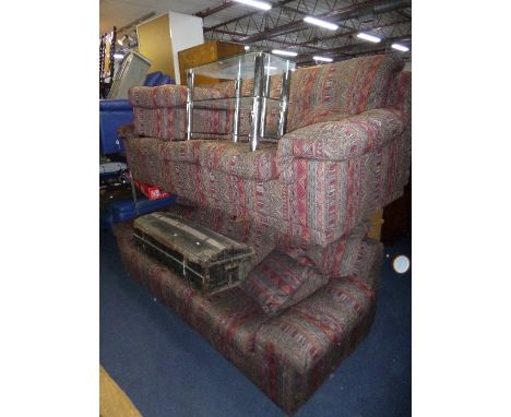 AN UPHOLSTERED THREE PIECE LOUNGE SUITE, comprising of two three seater settee's and a pouffe, (stevens label attached)