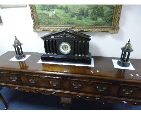 A BLACK MARBLE ARCHITECTURAL MANTEL CLOCK GARNITURE, having circular enamelled dial with Arabic numeral, four pillars either 