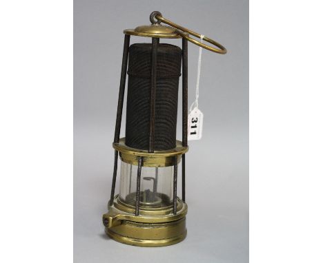 A BRASS AND GAUZE DAVY MINERS LAMP, having brass domed top impressed CLN 206 over tapering central gauze section over burner,