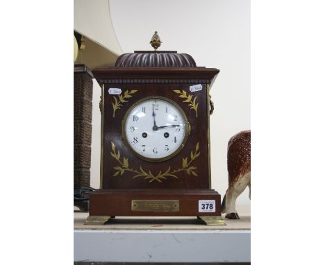 AN EDWARDIAN MAHOGANY AND BRASS INLAID BRACKET CLOCK, Pineapple finial, enamel dial, Arabic numerals, bears presentation plaq