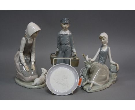 A LLADRO FIGURE, of a girl seated with a dove, a Nao figure of a girl kneeling beside a lamb, a Lladro pin dish and a damaged