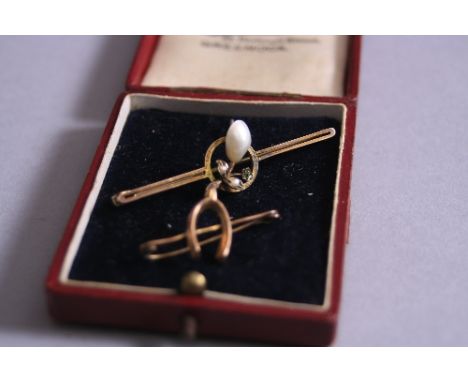 TWO EARLY 20TH CENTURY BAR BROOCHES, to include a pearl and demantoid garnet bar brooch measuring approximately 50mm in lengt