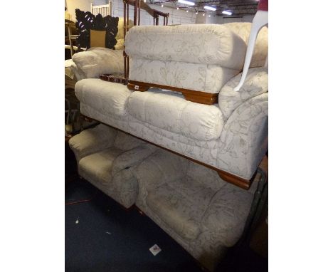 AN UPHOLSTERED THREE PIECE SUITE, comprising of a two seater settee, a pair of armchairs and a pouffe (4)