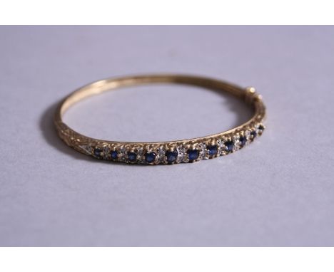 A 9CT DIAMONDS AND SAPPHIRE SET BANGLE