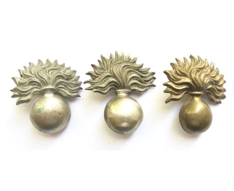 3 Artillery helmet badges.Two die-stamped white metal grenades and another in brass. Two toned loops to each.