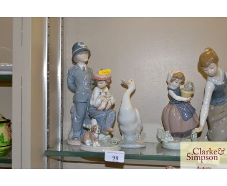 A Nao figure of a duck; a Lladro figure of a policeman; and a Lladro figure of a boy seated on a milestone