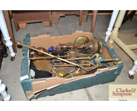 A box of miscellaneous metal ware; to include brass fireside implements, copper candlestick etc. 