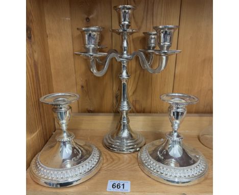 A silver plate candelabra and a pair of silver plate candlesticks.