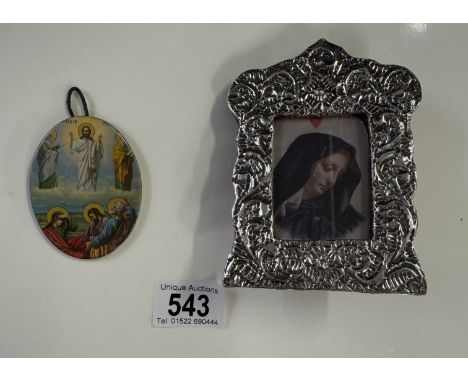 An un-marked silver framed religious print and a metal oval miniature religious plaque.