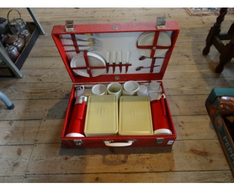 A circa 1950's Sirram travelling picnic box and contents, to include: flask, lidded boxes, flatware, plates and other items.