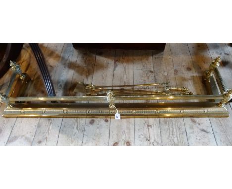 A Victorian-style brass fender (128cm), together with three brass fire tools.