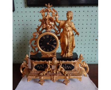 A gilt metal mantle clock in the rococo-style, the black slate dial bearing Roman numerals and the striking movement numbered