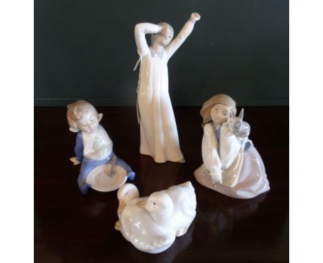 Four Nao figurines to include: a young girl with a rabbit, a baby and others.