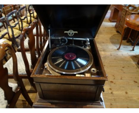 A Columbia Viva-Tonal Grafonola record player in an oak case. Condition Report: Good overall condition and in working order.
