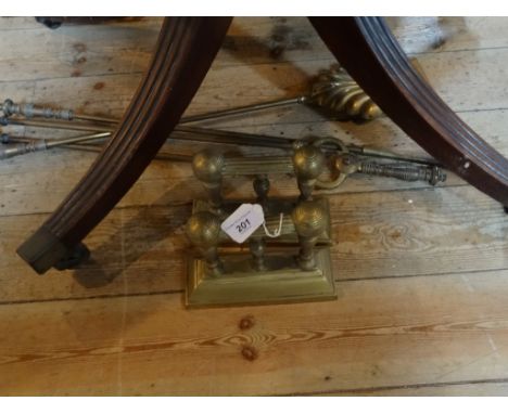 A pair of 19th century brass fire dogs, together with three brass fire tools.