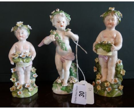 A 19th century Derby-style porcelain figurine, modelled as a putti, wearing a purple sash and adorned by encrusted flowers, p