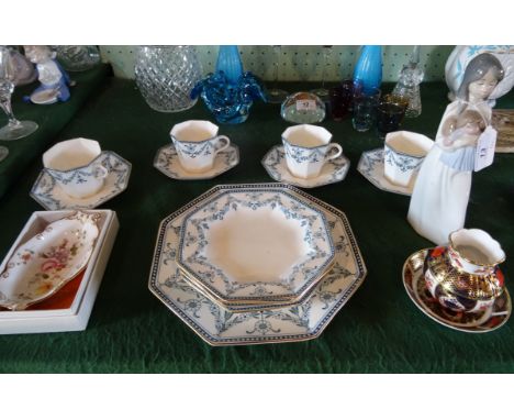 A Wedgwood part-tea service, four place setting, comprising: hexagonal shaped side plates, cups and saucers and a cake plate,