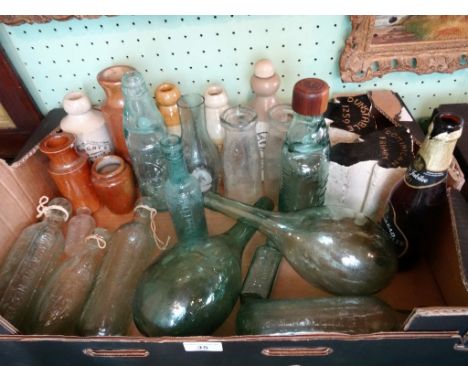 A interesting collection of 19th century and later stoneware and glass bottles, together with two pieces of stone 'excavated 