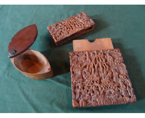 An Oriental hardwood card case, having heavily carved decoration depicting figures, buildings and tree (11.5cm x 8cm), togeth