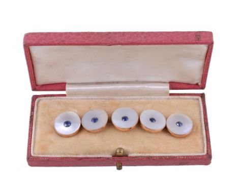 Ω A set of five Edwardian mother of pearl and sapphire buttons, the circular mother of pearl panels each set with a cushion c