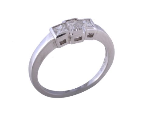  A three stone diamond ring,   the central step cut diamond with canted corners between two princess cut diamonds, approximat